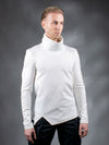A person wearing a white high collar, asymmetrical cut futuristic sweater.