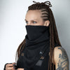 Black infinity scarf face cover on female model with braided hair, textured jersey snood with geometric tag, cyberpunk techwear styling, neutral studio background
