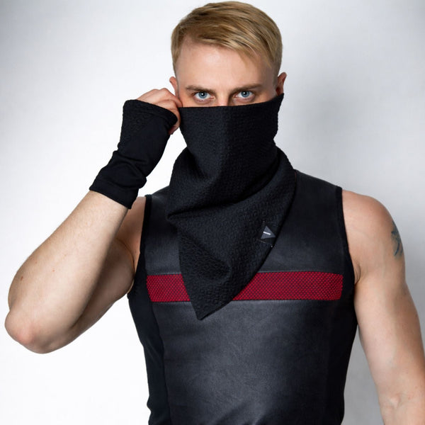 Black face cover infinity scarf pulled up over nose, textured stretch snood with structured drape, techwear styling on male model, clean light background