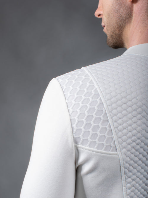 Close-up of white textured jersey shoulder panel on futuristic pullover – ZOLNAR