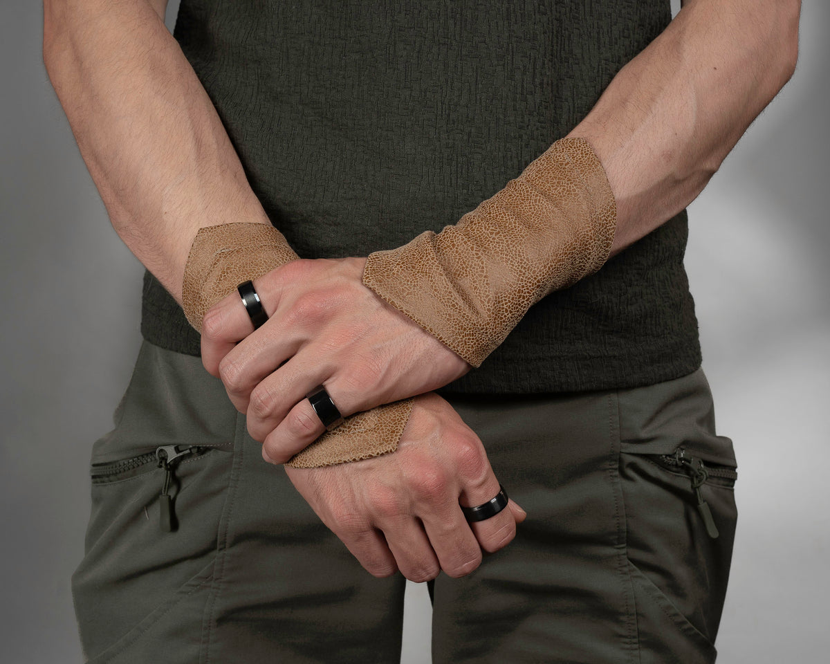 Man wearing beige faux leather armbands with uneven hem, ren faire bracers – ZOLNAR