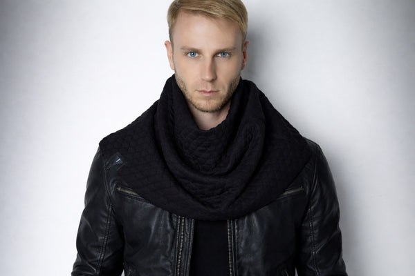 Leather jacket outfit with black quilted scarf, structured drape and textured fabric, men’s techwear styling, minimal studio portrait, cyberpunk aesthetic