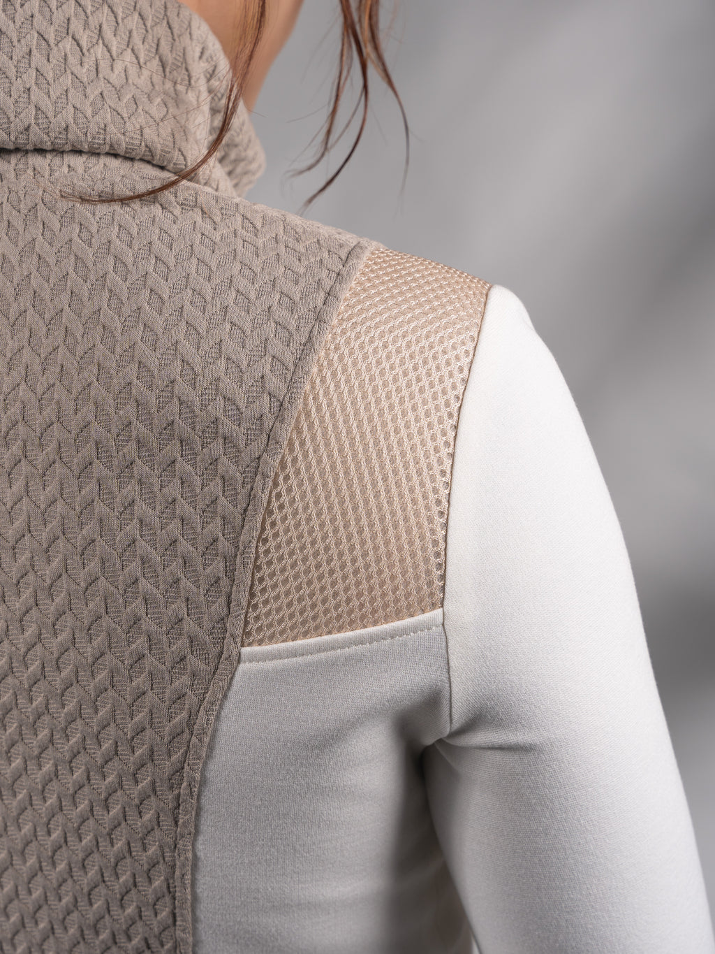 Close-up of beige cable-textured turtleneck collar and back panel – ZOLNAR