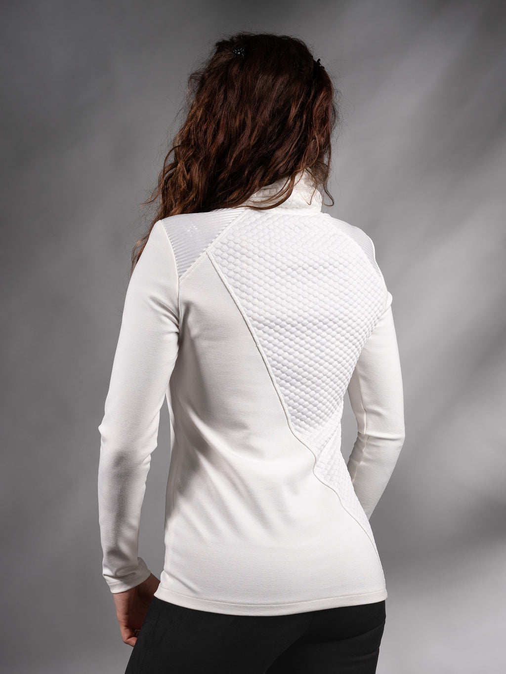 Back three-quarter view of white sweater with diagonal textured panel, minimalist – ZOLNAR