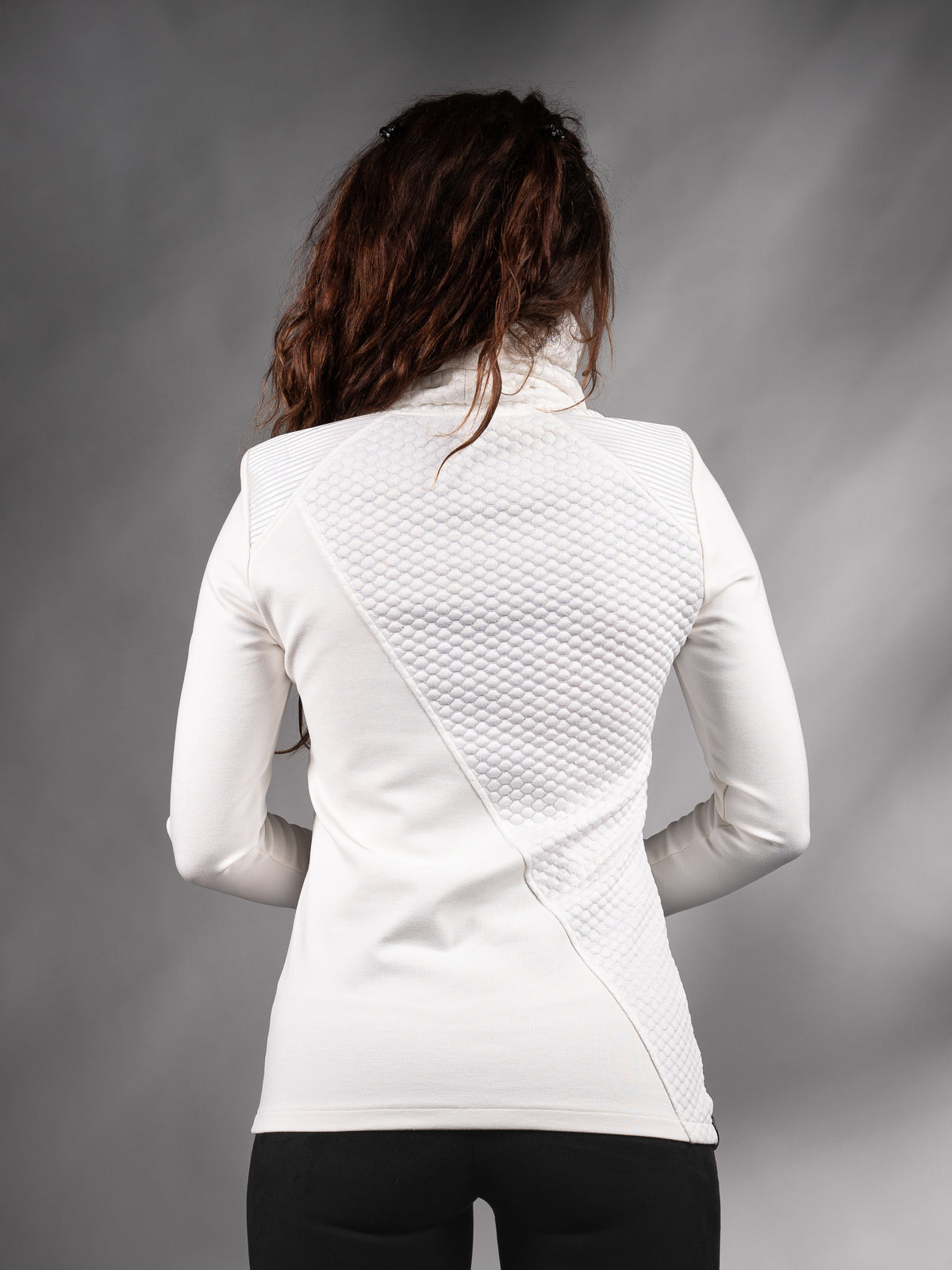 Back view of white asymmetrical sweater with quilted back panel – ZOLNAR