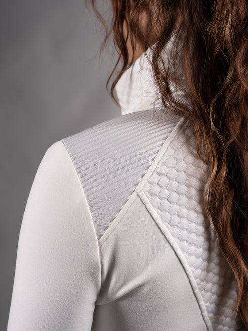 Close-up of quilted textured jersey panel on the shoulder of white sweater – ZOLNAR