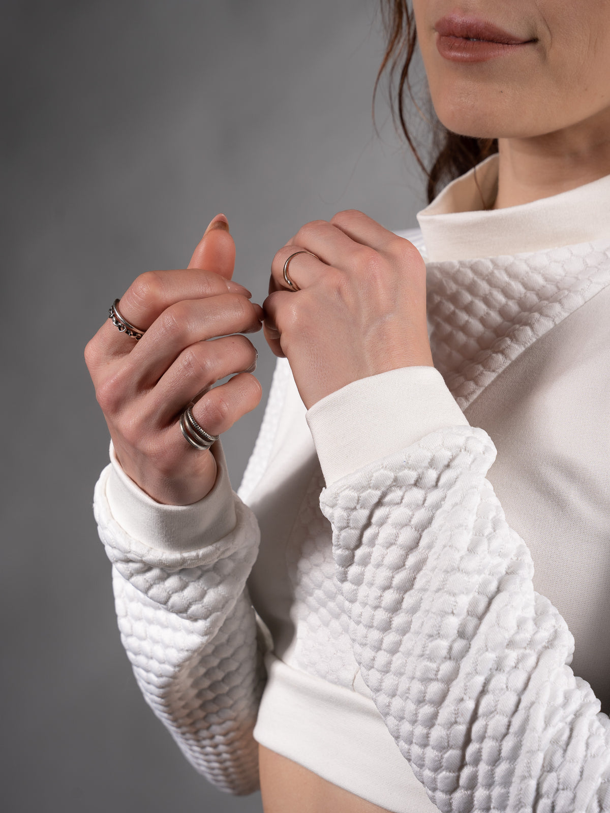 Close-up of quilted textured sleeve and cuff on white crop top – ZOLNAR