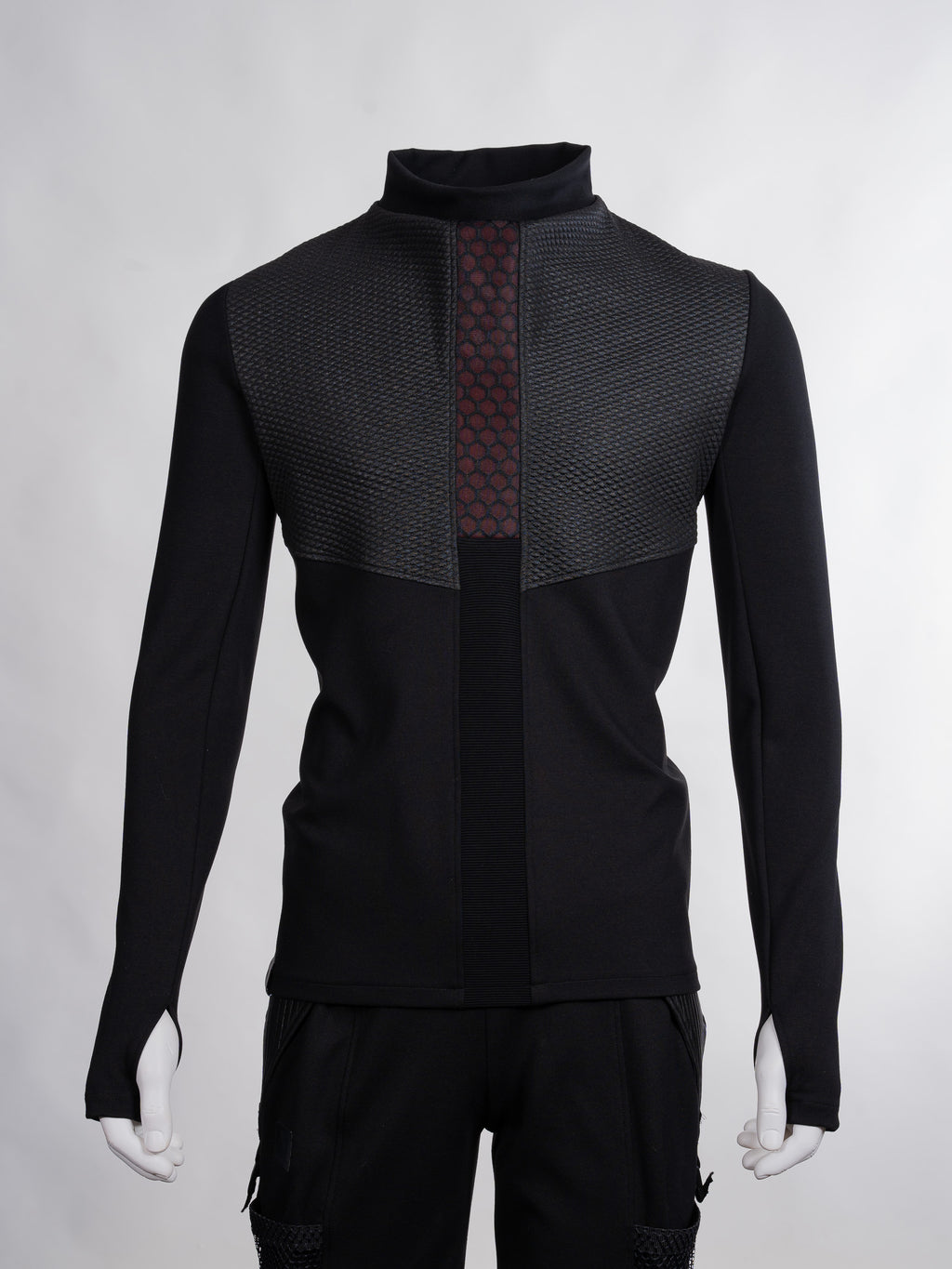 Black jacket with geometric pattern on a gray background
