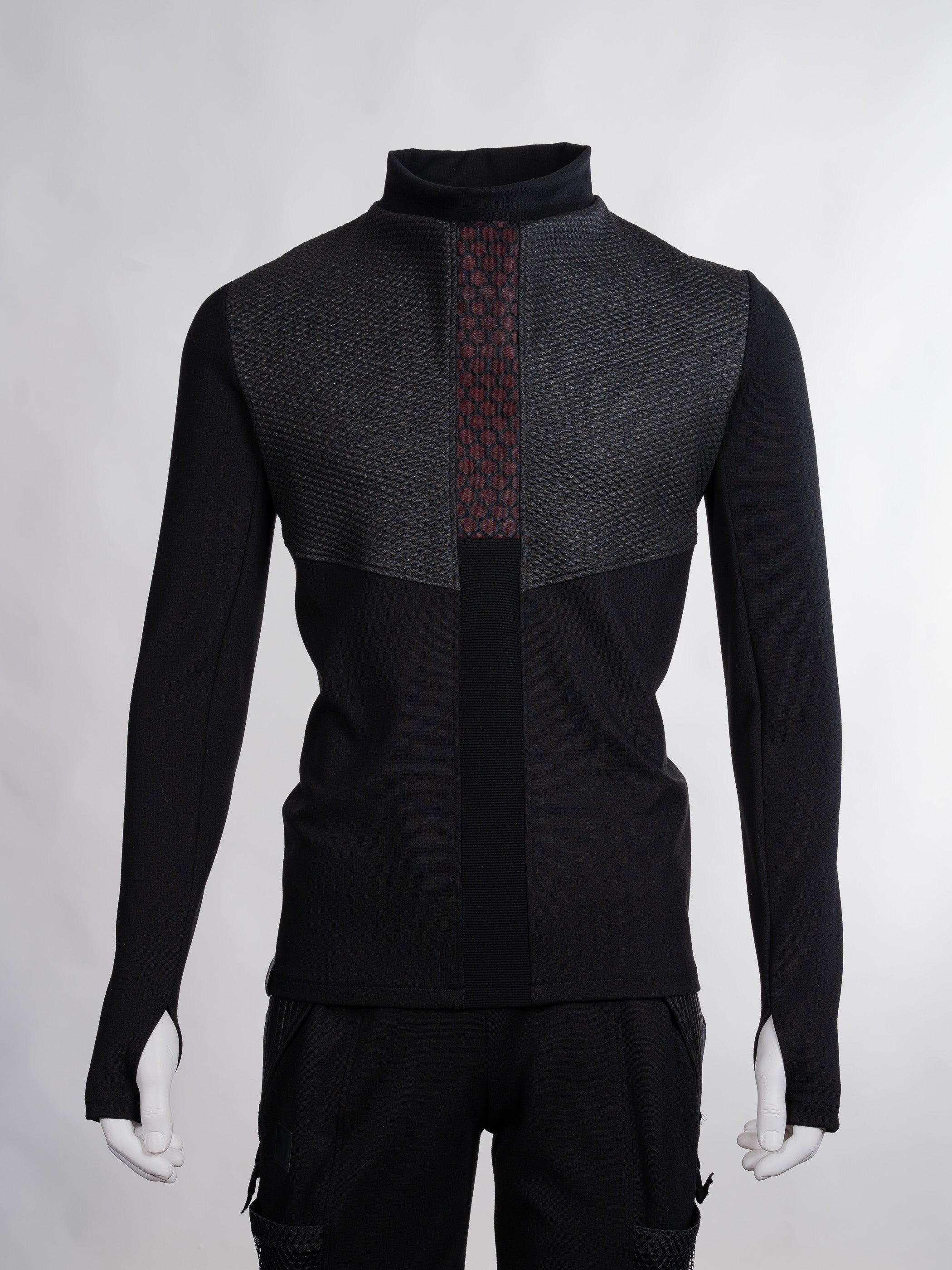Black jacket with geometric pattern on a gray background