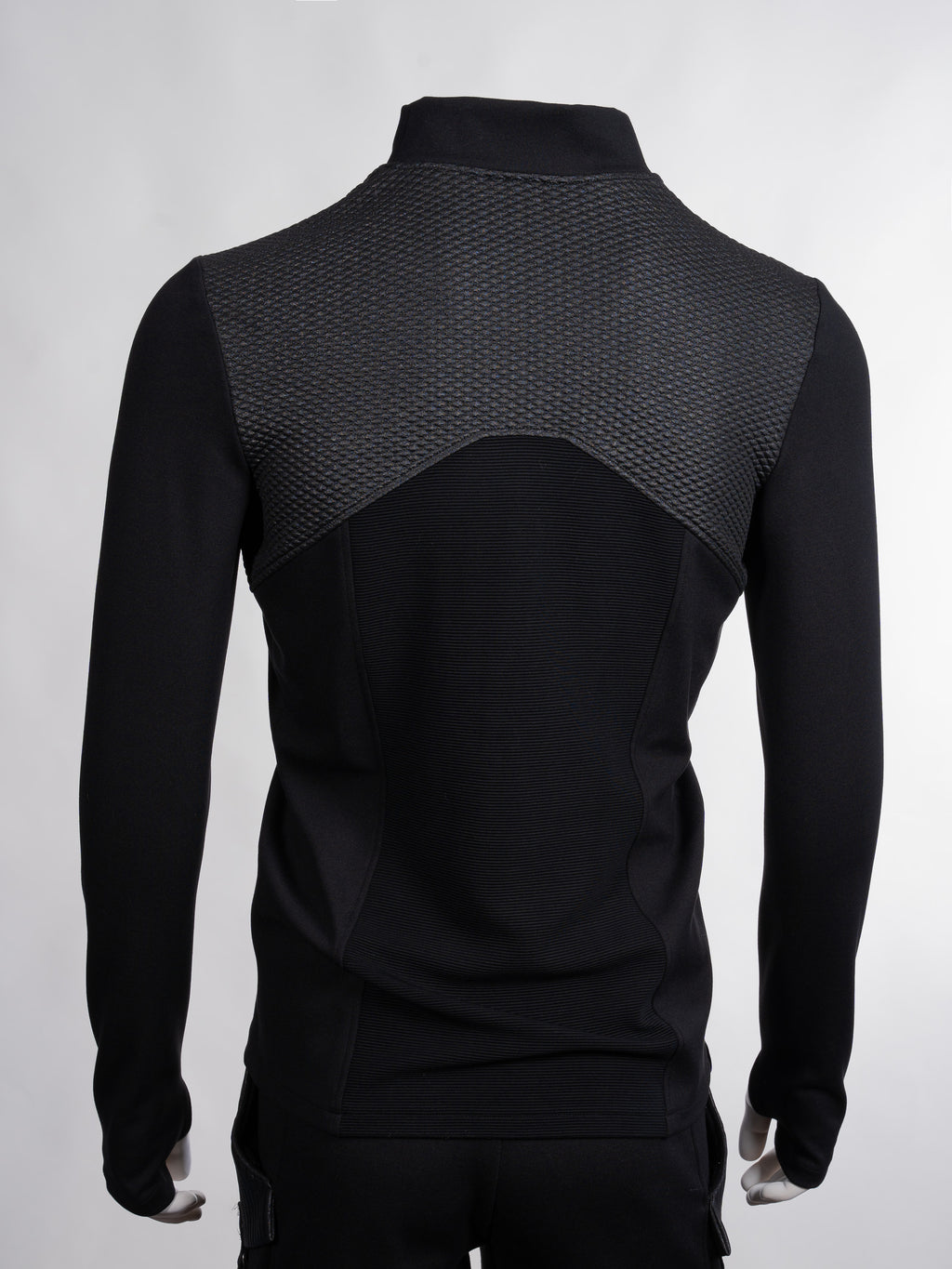 Black long-sleeve athletic jacket with textured back on a white background