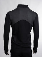 Black long-sleeve athletic jacket with textured back on a white background