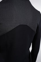 Black textured top on a mannequin against a white background